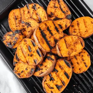 Fire up your grill for these perfectly charred Grilled Sweet Potatoes! With a sweet and smoky flavor, they make a fantastic side dish for any barbecue or picnic. Featuring just the right amount of seasoning, they're not only easy to make but also packed with nutrients. Save this recipe for your next outdoor gathering!