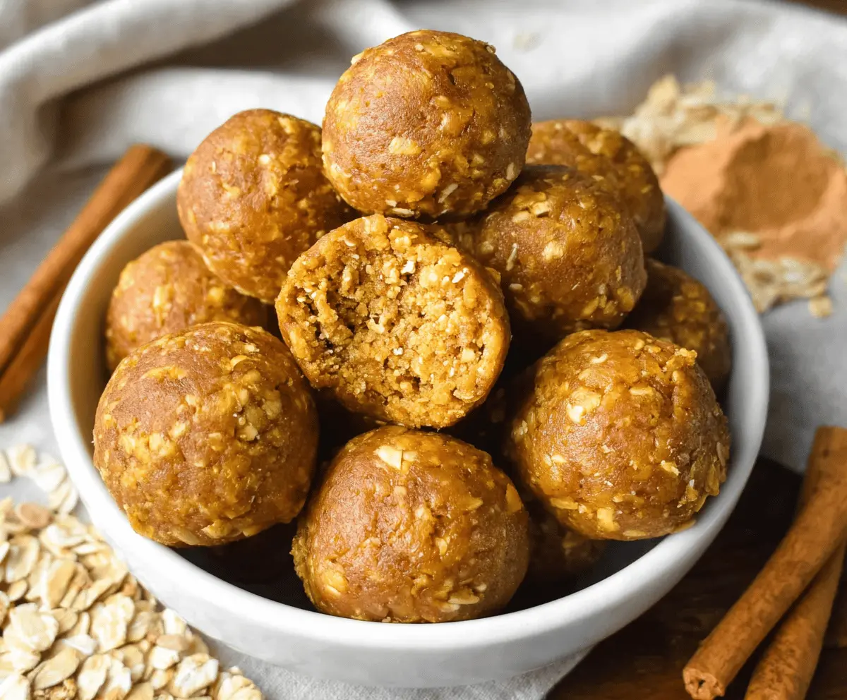 Healthy pumpkin spice protein balls on a white plate, garnished with cinnamon and chia seeds, perfect for a nutritious snack.