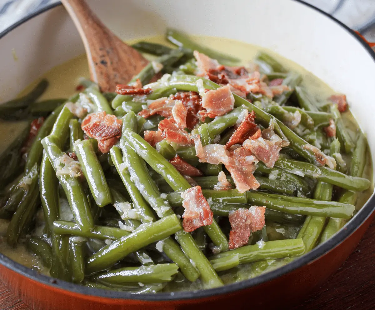 Fresh Southern Style Green Beans cooked with bacon and seasoned with garlic and onions in a rustic bowl.