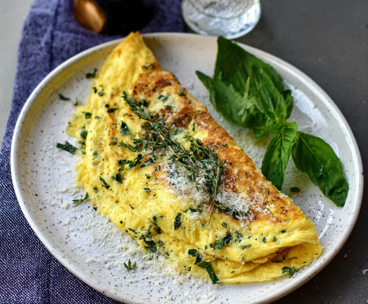 Delicious Parmesan Herb Omelet with fresh herbs and melted cheese, perfect for a nutritious breakfast.