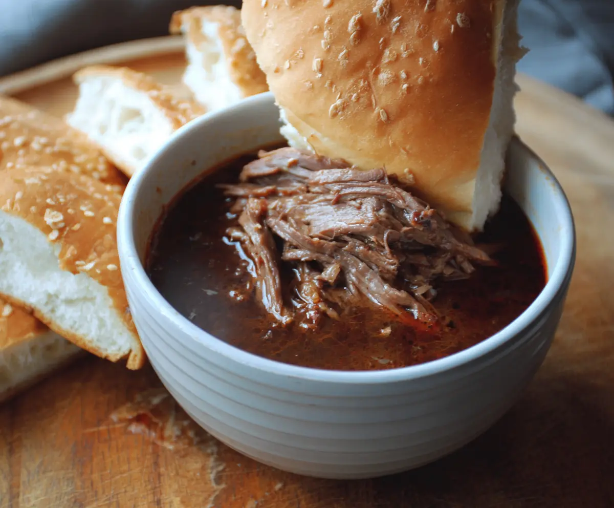 Delicious 5 Ingredient Beef Dip in a bowl with fresh herbs
