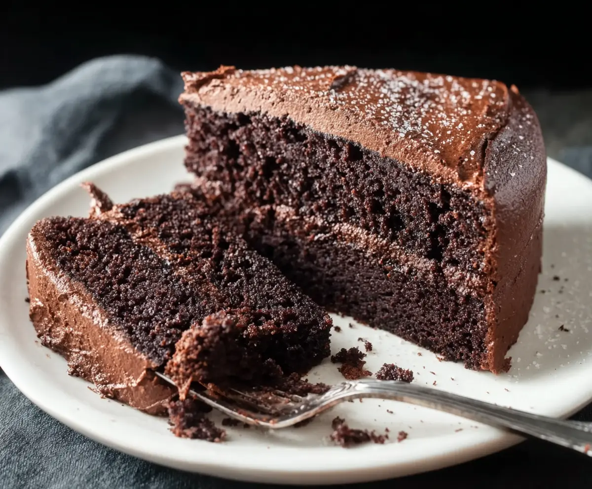 Delicious sourdough discard chocolate cake on a plate, showcasing a moist, rich dessert ready to serve.