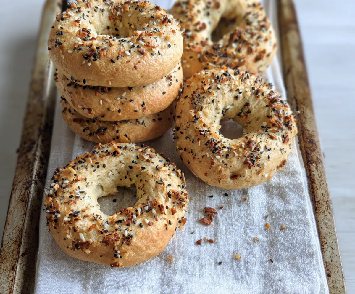 Delicious homemade almond flour Greek yogurt bagels on a wooden cutting board.