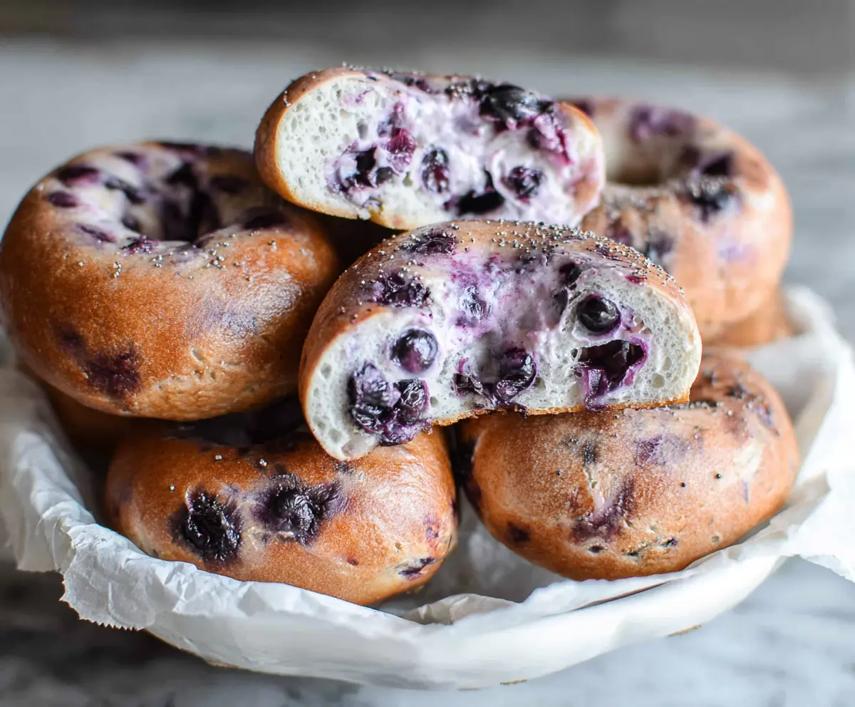 Freshly baked blueberry bagels with vibrant blueberries and a golden crust.