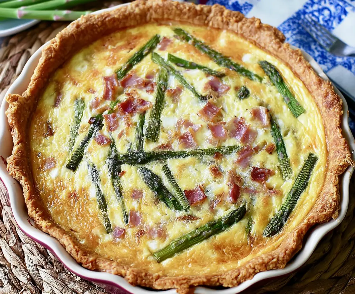 Delicious Ham and Asparagus Quiche with a golden crust and fresh ingredients.